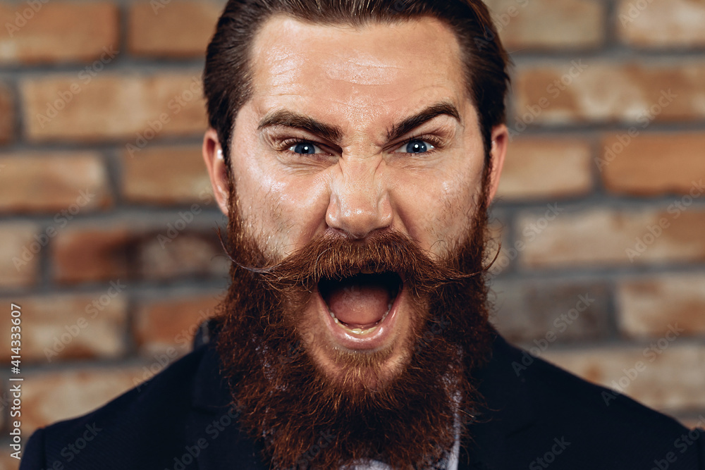 Portrait of a charismatic handsome man wearing a suit, hussar mustache
