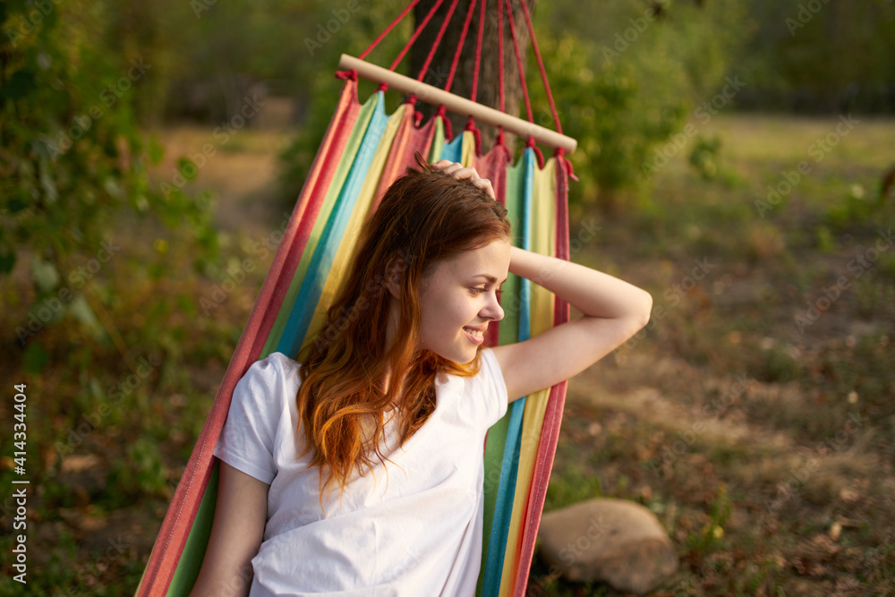 happy woman lies in a hammock outdoors in the forest laughing happy woman lies in a hammock outdoors in the forest laughing