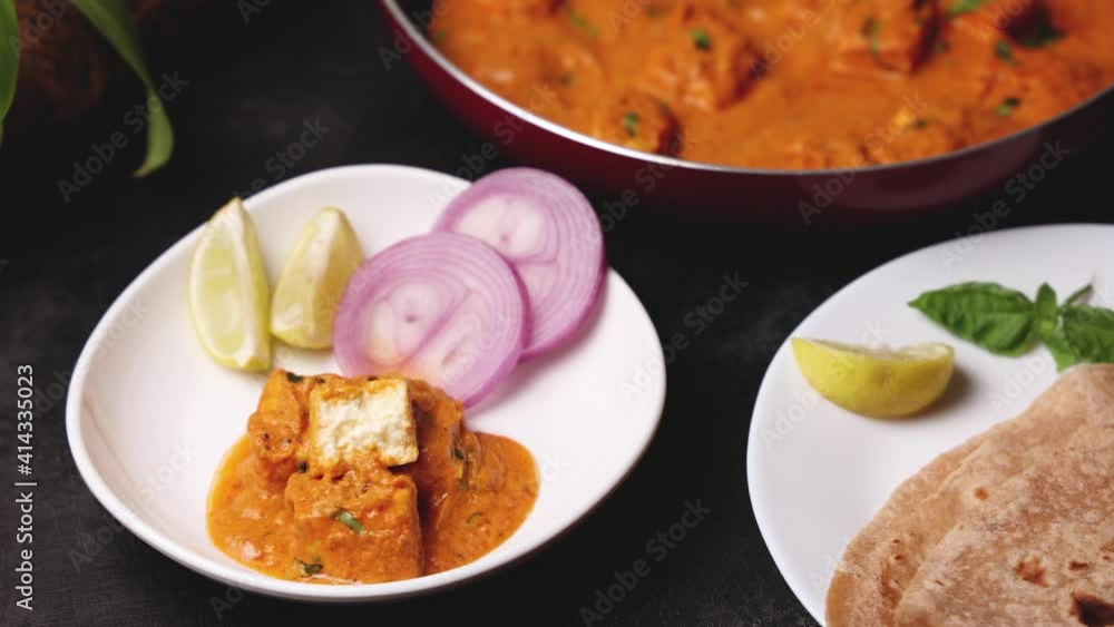 Woman hand eating Paneer butter masala , Paneer tikka masala curry