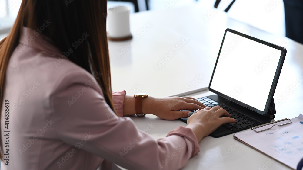 Businesswoman analyst browsing business data online report on tablet computer. Businesswoman analyst browsing business data online report on tablet computer.