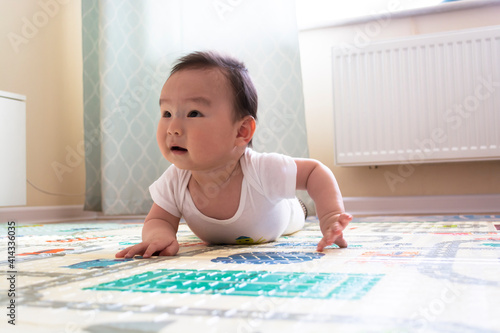 Asian baby boy laying on floor