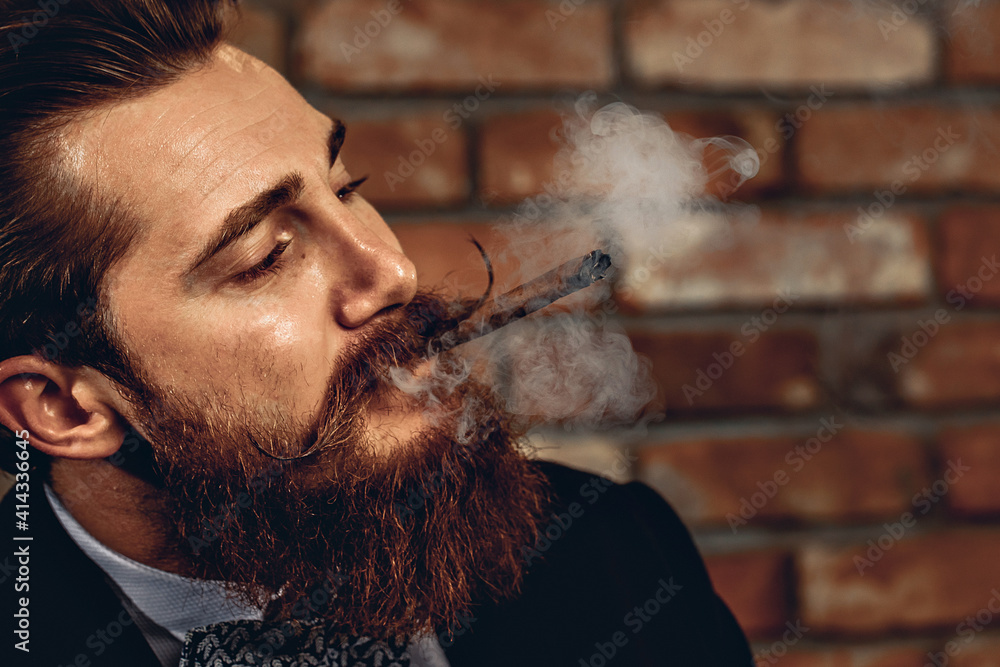 Portrait of an attractive sharming man with a hussar mustache and beard
