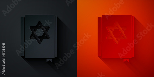 Paper cut Jewish torah book icon isolated on black and red background. Pentateuch of Moses. On the cover of the Bible is the image of the Star of David. Paper art style. Vector.
