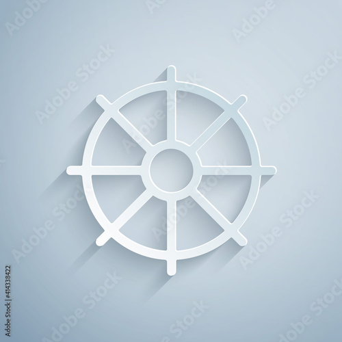 Paper cut Dharma wheel icon isolated on grey background. Buddhism religion sign. Dharmachakra symbol. Paper art style. Vector.