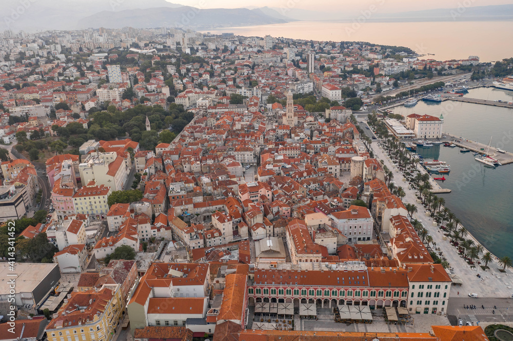 Aerial drone west side view of Diocletian Palace by riva in Split old town in Croatia in sunrise