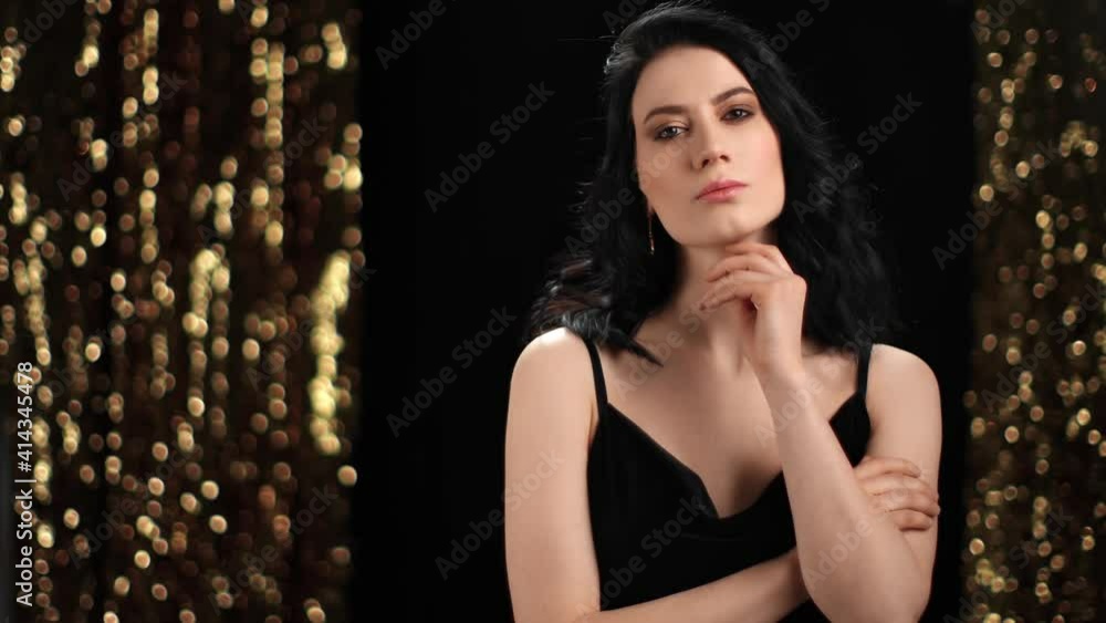 Fashionable mixed race lady in black evening dress posing at light bokeh. Shot with RED camera in 4K Fashionable mixed race lady in black evening dress posing at light bokeh. Shot with RED camera in 4K