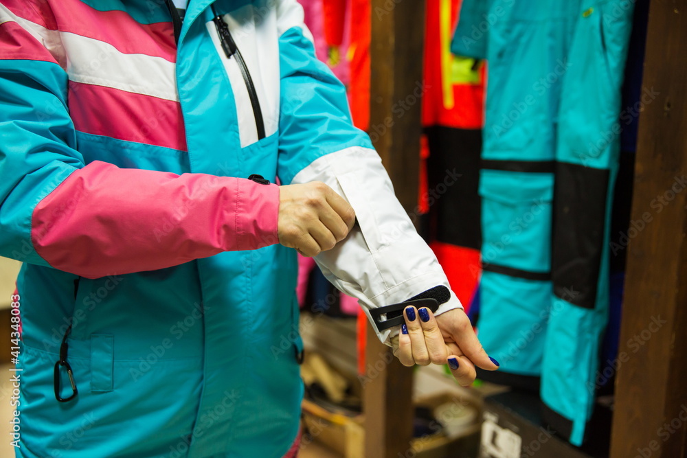 woman trying on ski suit in store woman trying on ski suit in store