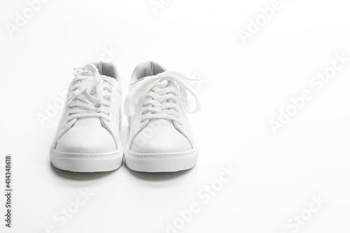 Pair of White Sneakers Over White Background.