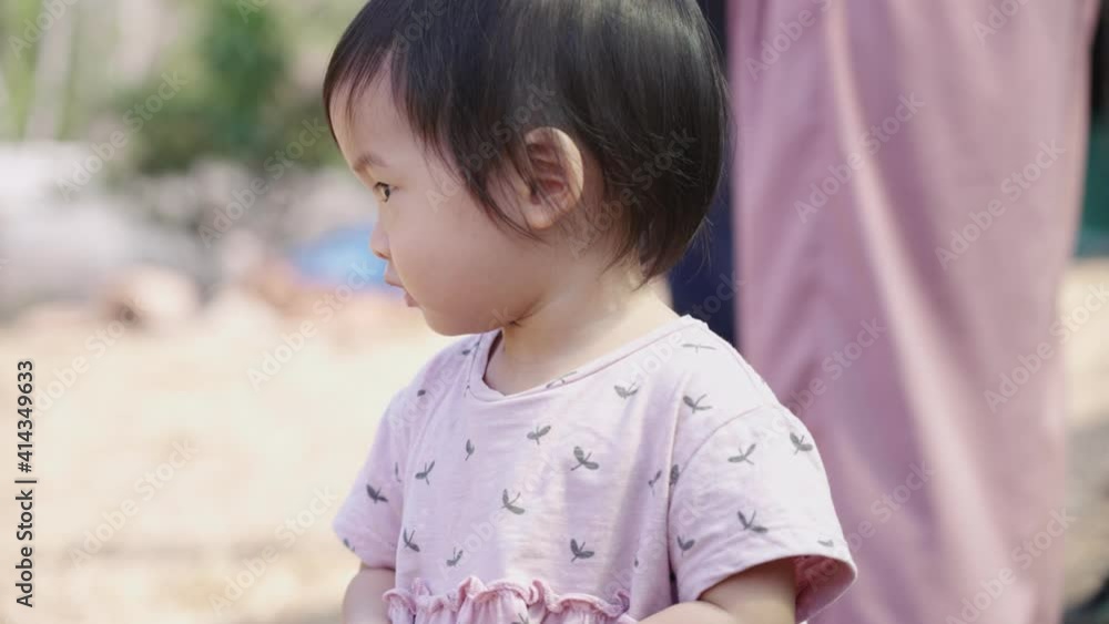 Asian female toddler with family at the recreation outdoors park, child development, baby girl toddler beginning of new life, innocence purity of young age, imagination curiosity, looking away Asian female toddler with family at the recreation outdoors park, child development, baby girl toddler beginning of new life, innocence purity of young age, imagination curiosity, looking away