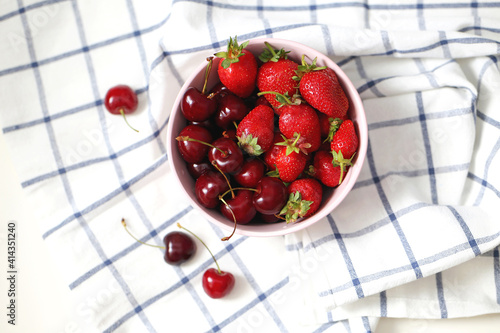 Fresh strawberries and cherries in a plate. Summer berries