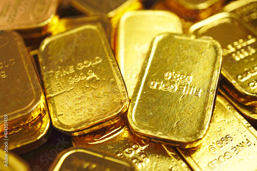 Selective focus on gold bars which spread on the table , investment concept .