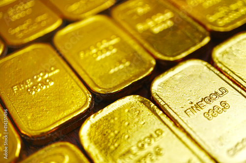 Selective focus on gold bars surface which array on the table , investment concept . photo