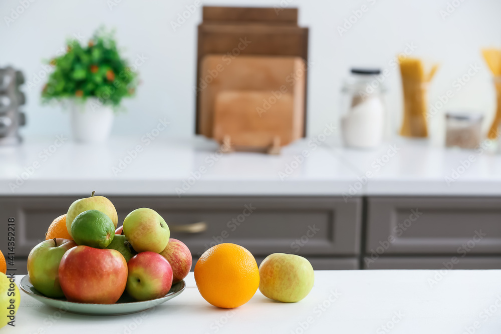 Plate with fruits on table in modern kitchen Plate with fruits on table in modern kitchen