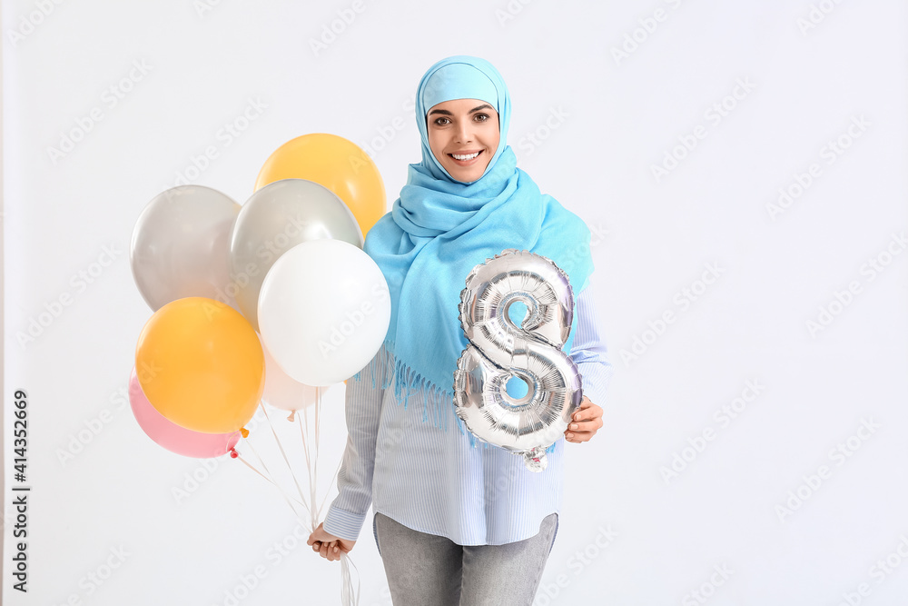 Beautiful Muslim woman with gifts on white background. International Women's Day celebration Beautiful Muslim woman with gifts on white background. International Women's Day celebration