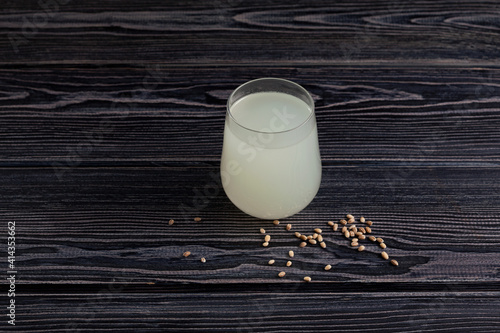 Rejuvelac or home made kvass on dark wooden background. Healthy fermented drink. Natural probiotic made by soaking grain or pseudocereal (usually sprouted) in water photo