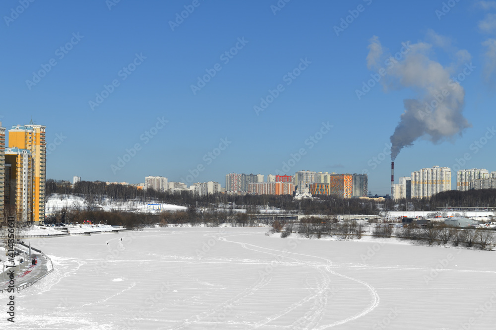 Fototapeta premium Snow-covered Moskva River and Mitino District. Moscow, Russia