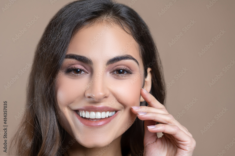 Close-up face of young adult smiling woman Close-up face of young adult smiling woman