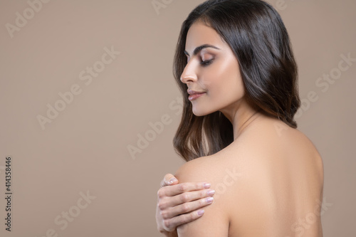 Profile of womans face with bare shoulder