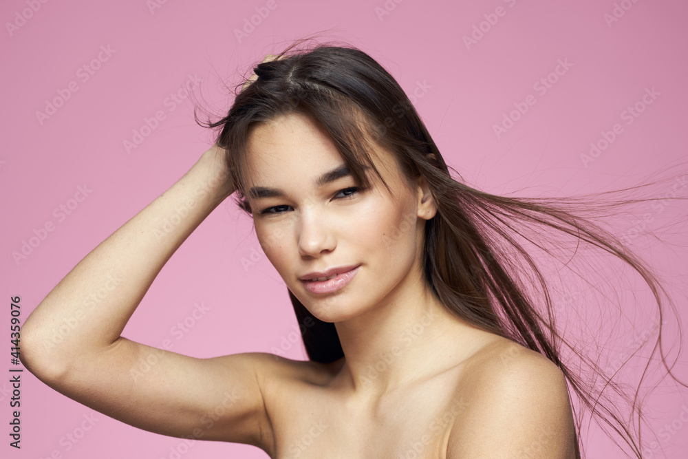 Pretty brunette naked shoulders clear skin pink background Pretty brunette naked shoulders clear skin pink background