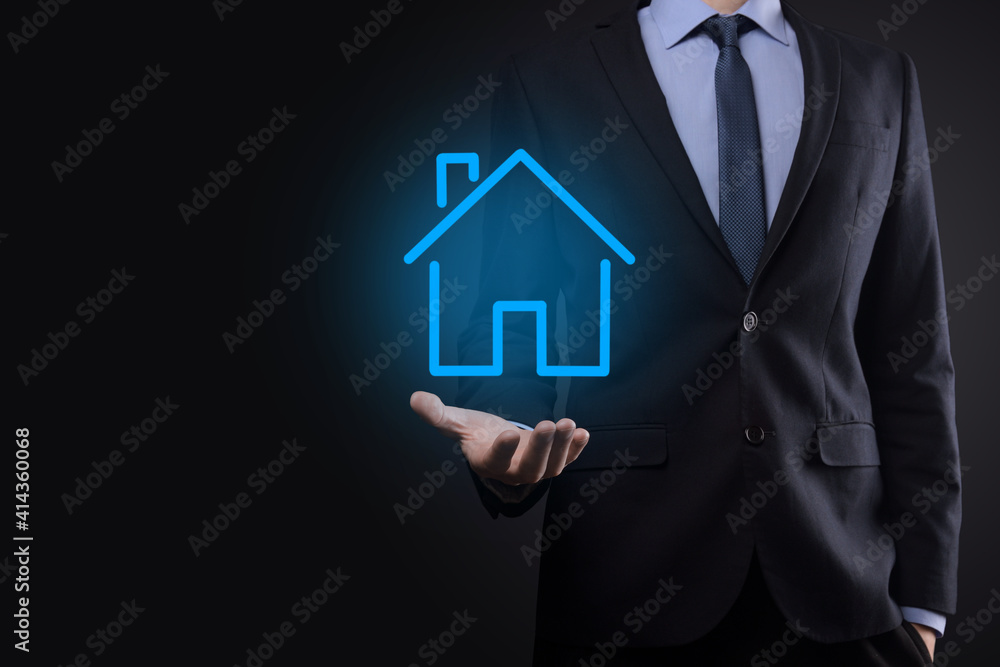 Real estate concept, businessman holding a house icon.House on Hand.Property insurance and security concept. Protecting gesture of man and symbol of house.