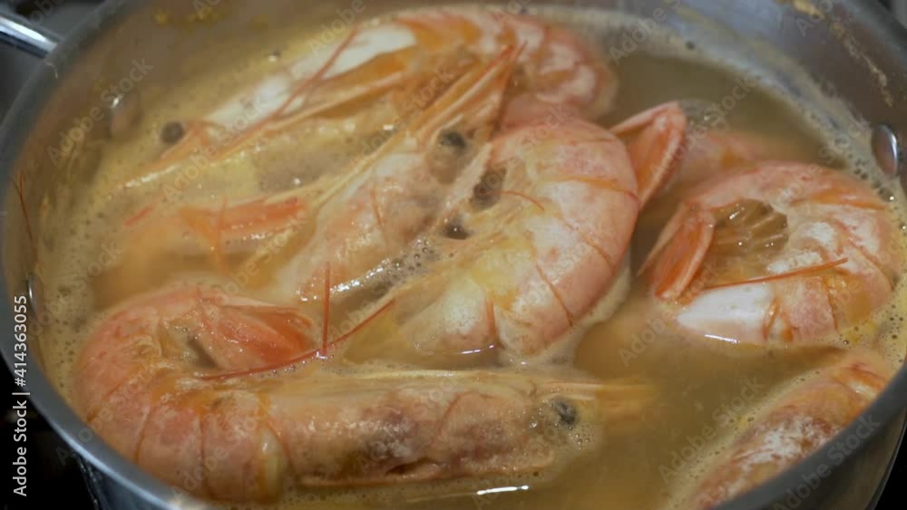 The Process of Boiling Large Shrimps in a Saucepan, Close-up. Cooking Food, Lots Of Food, Shrimps. Delicious and Healthy Food. The Process of Boiling Large Shrimps in a Saucepan, Close-up. Cooking Food, Lots Of Food, Shrimps. Delicious and Healthy Food.