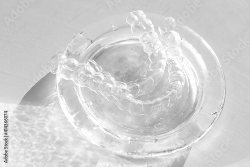 Obraz na płótnie Invisible transparent aligners plastic braces dentistry retainers on glass w salonie