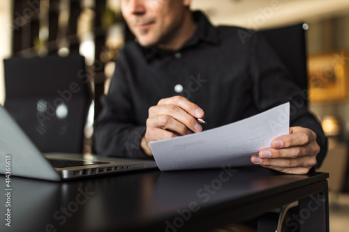 Close-up image of a businessman working on reports.