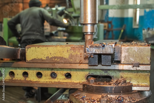 The work of the milling machine close-up. On the background of the workers