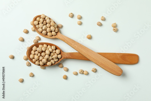 Spoons with fresh chickpea on white background
