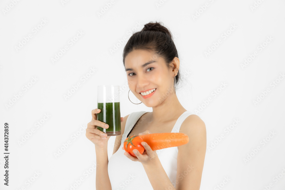 Beautiful young Asian woman drinking green detox vegetable smoothie over white isolated background. Fitness and health care concept, Vegetarian drink juice, Healthy lifestyle.