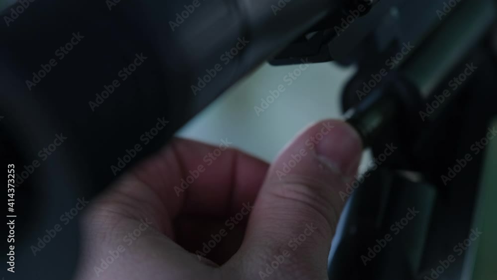 The man is loading a cartridge into a gun. Hunter's hand is loading a bullet into a carbine. The man is loading a cartridge into a gun. Hunter's hand is loading a bullet into a carbine.