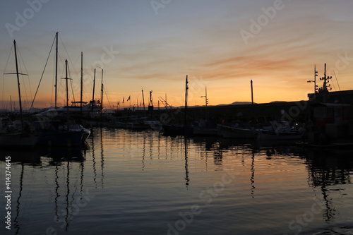 silhouettes of masts of ships in Saint Tropez harbour at sunset
