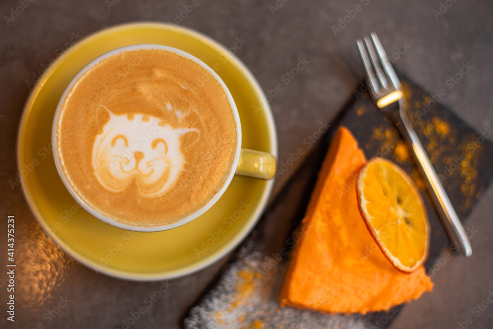 Coffee latte with orange cheese cake in cafe. Food, breakfast concept Coffee latte with orange cheese cake in cafe. Food, breakfast concept
