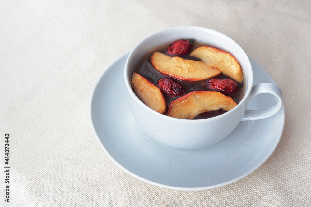 tea with dried apples and rosehip in a white cup tea with dried apples and rosehip in a white cup