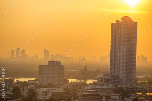 The blurred abstract background of the morning sun exposure to the tiny dust particles that surround the tall buildings in the capital  the long-term health issue of pollution