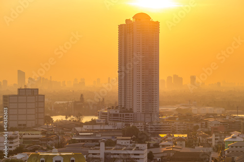 The blurred abstract background of the morning sun exposure to the tiny dust particles that surround the tall buildings in the capital  the long-term health issue of pollution