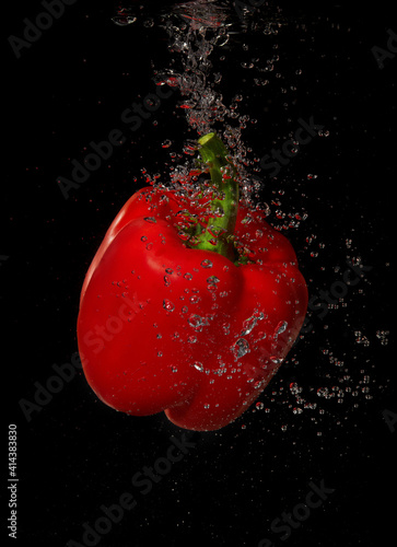 Red pepper splashing in water