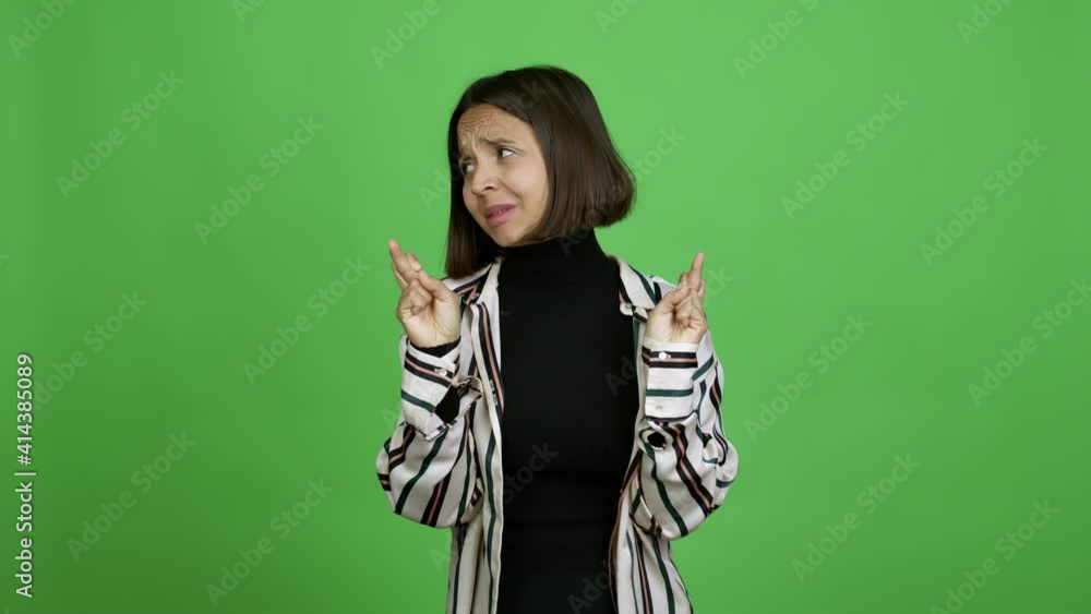 Woman with fingers crossing and wishing the best. Making a wish over isolated background Woman with fingers crossing and wishing the best. Making a wish over isolated background