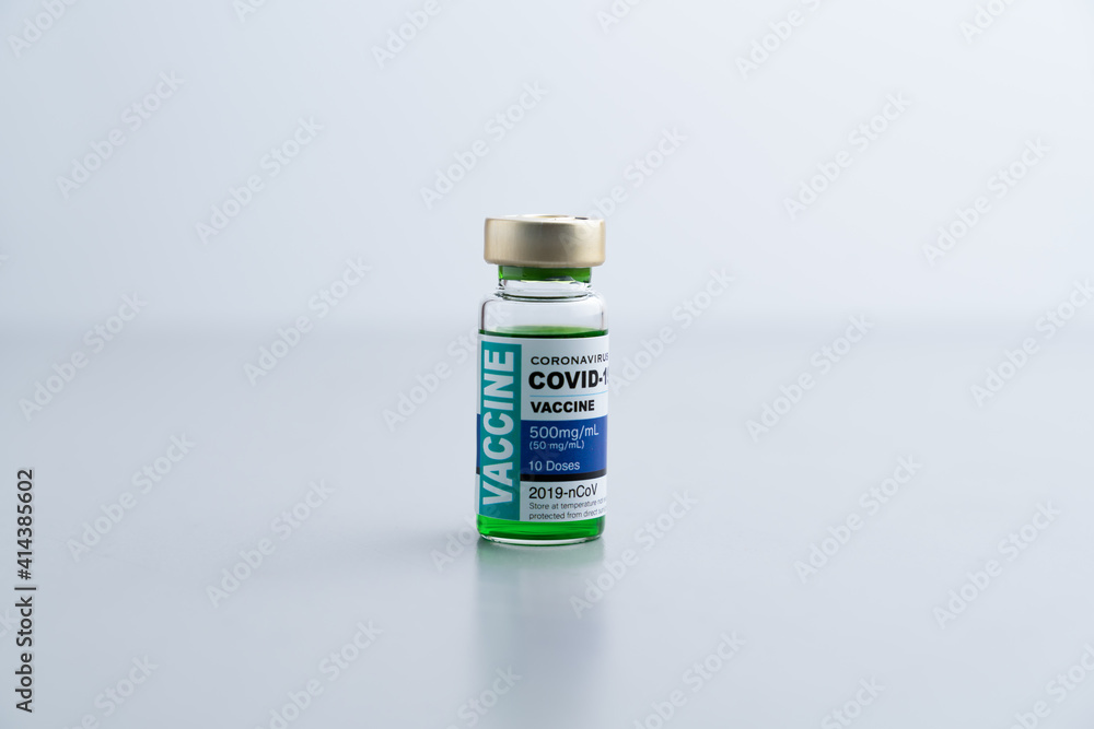 ampoules or vials with Covid-19 vaccine on a laboratory bench. SARS-CoV-2 Vaccination, immunization, treatment to cure Covid 19 Corona Virus infection. Medical concept.