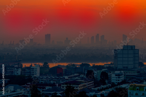 The blurred abstract background of the morning sun exposure to the tiny dust particles that surround the tall buildings in the capital  the long-term health issue of pollution