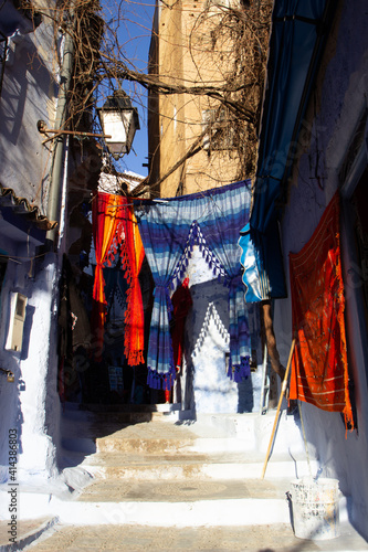 colorful street and cloth at Chefchaouen, Morocco  © mitake
