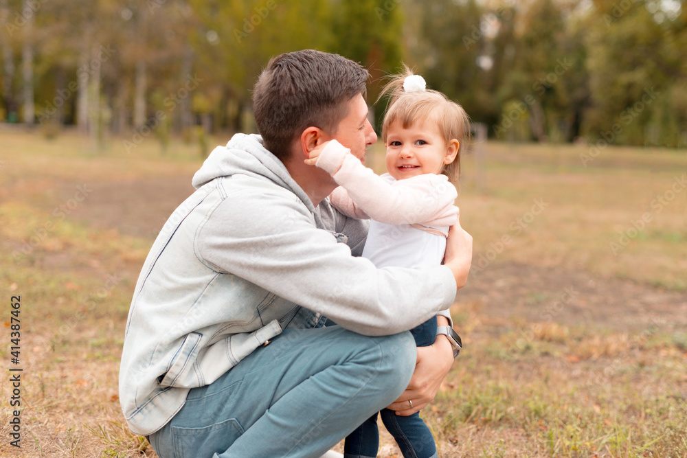 Cheerful little girl having time with her father outdoor. Cheerful little girl having time with her father outdoor.