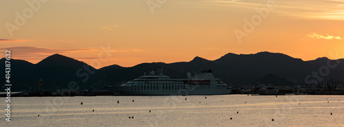 cruise ship at sunset on the sea coast