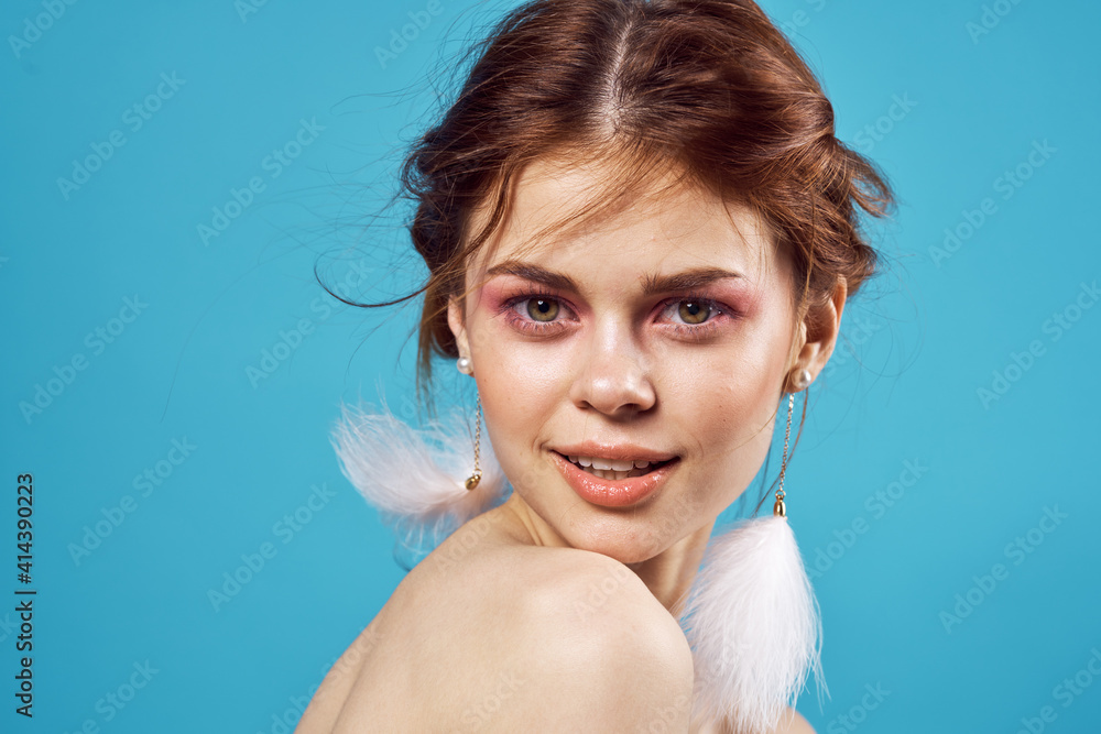 attractive woman naked shoulders fluffy earrings bright makeup jewelry blue background attractive woman naked shoulders fluffy earrings bright makeup jewelry blue background