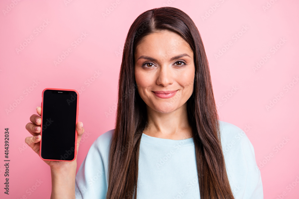 Photo portrait of brunette showing smartphone touchscreen copyspace isolated on pastel pink color background Photo portrait of brunette showing smartphone touchscreen copyspace isolated on pastel pink color background
