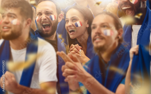 Fotografie Francian football, soccer fans cheering their team with a blue scarfs at stadium