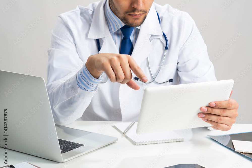 Close up of doctor hands using tablet computer Close up of doctor hands using tablet computer