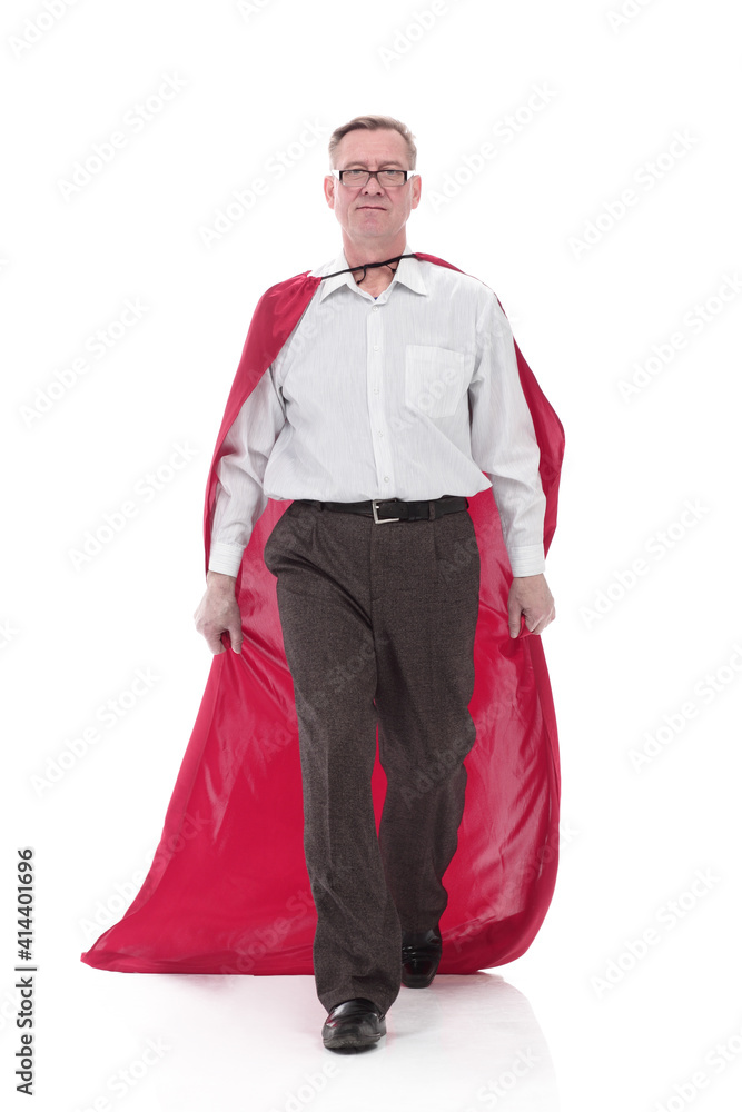 in full growth. Mature man in a superhero Cape striding forward.