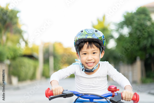 boy is riding bicycle at the park.