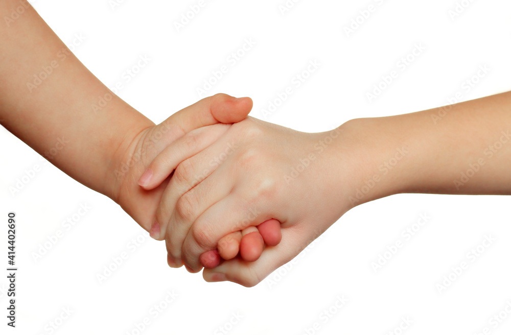hand of a child holds a hand of a child on a white background.Friendship, love, cooperation